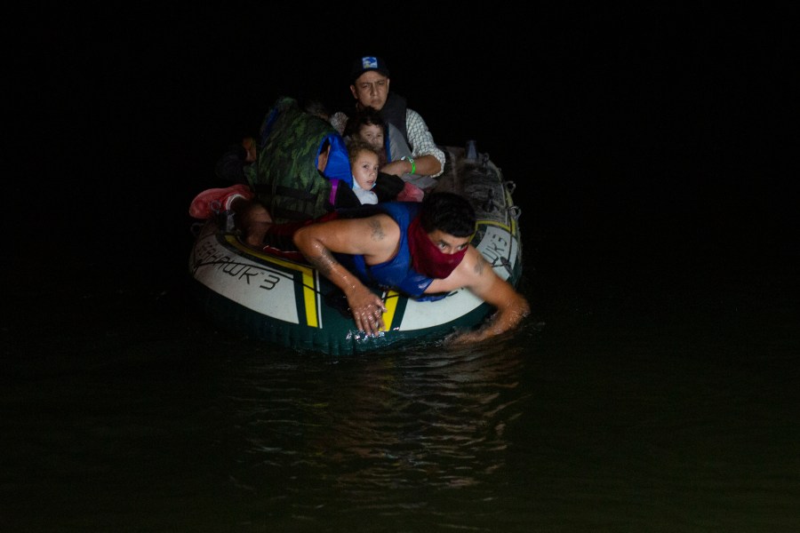 In this March 30, 2021 file photo, a smuggler takes migrants, mostly from Central American countries, on a small inflatable raft towards U.S. soil, in Roma, Texas. (Dario Lopez-Mills, Associated Press)