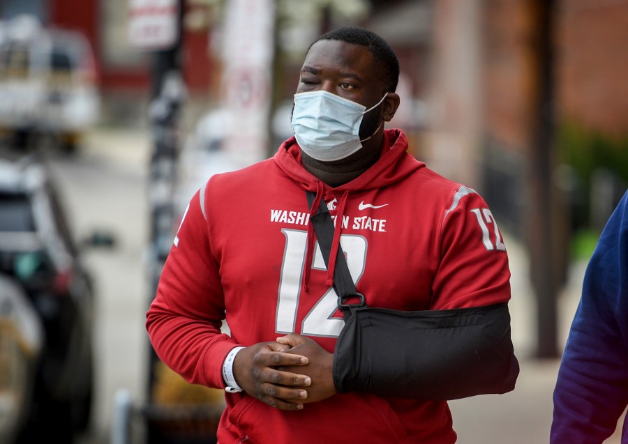 De'Vincent Spriggs walks outside of the Pittsburgh Police Zone 3 station on Wednesday, April 14, 2021, in Pittsburgh. Spriggs told Pittsburgh police Wednesday that Los Angeles Rams defensive lineman Aaron Donald and others assaulted the him at a nightclub last weekend, causing multiple injuries. (Steve Mellon/Pittsburgh Post-Gazette via AP)