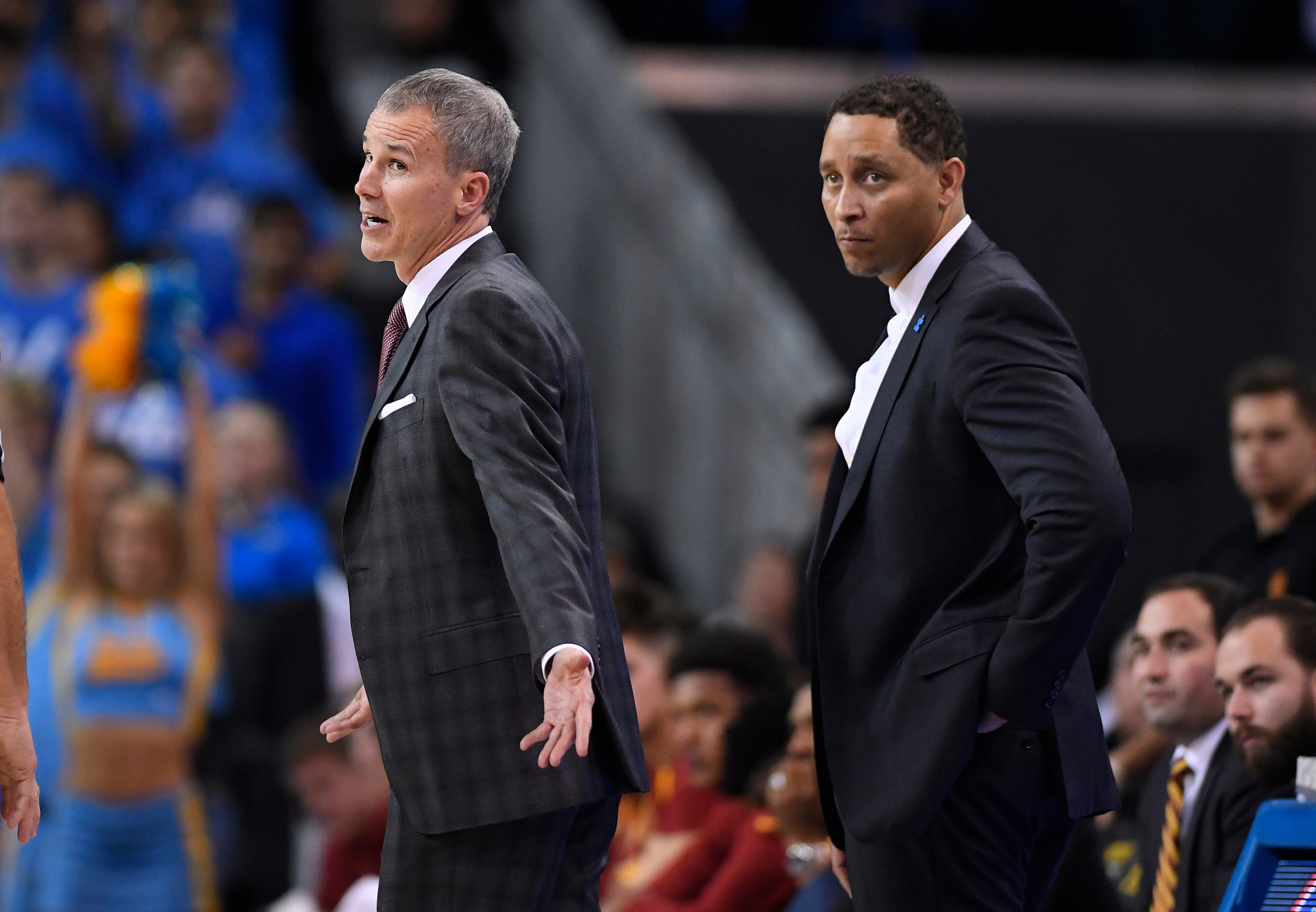 In this Feb. 18, 2017, file photo, Southern California head coach Andy Enfield, left, talks to officials as assistant coach Tony Bland stands behind him during the second half of an NCAA college basketball game against UCLA, in Los Angeles. The NCAA hit Southern California’s men's basketball program with two years’ probation and a $5,000 fine as the result of a former assistant who violated NCAA ethical conduct rules when he accepted a bribe to steer players to a business management company. (AP Photo/Mark J. Terrill, File)