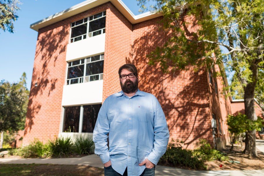 Chris Lambert, a musician and recording engineer, poses on April 15, 2021, in front of Muir Hall dormitory at California Polytechnic University in San Luis Obispo. (Nic Coury / Associated Press)