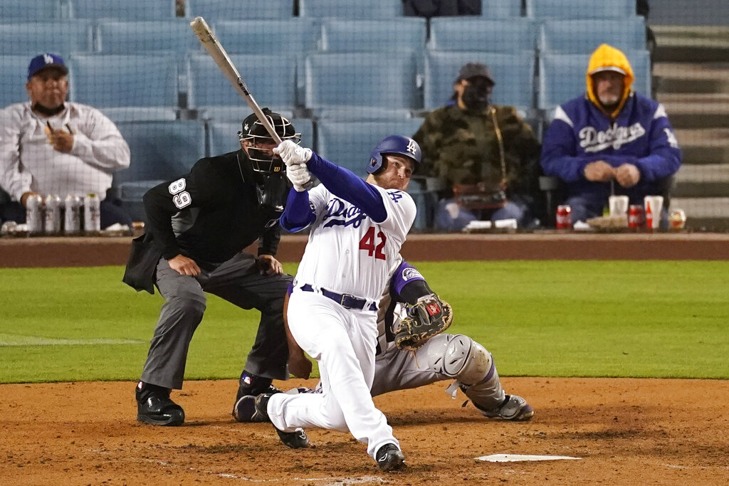 Los Angeles Dodgers' Max Muncy hits a home run during the seventh inning of a baseball game against the Colorado Rockies Thursday, April 15, 2021, in Los Angeles. Chris Taylor and Justin Turner also scored. (AP Photo/Ashley Landis)