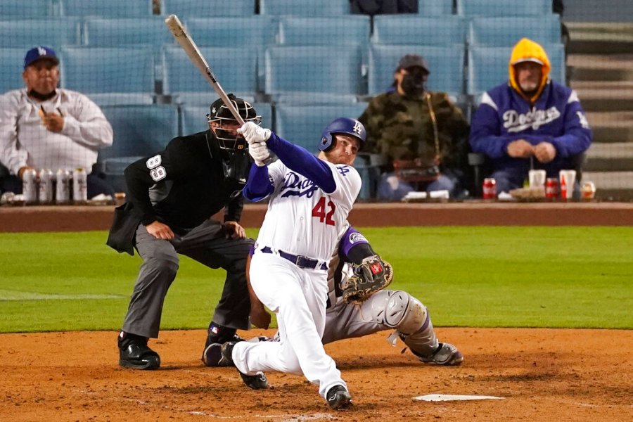 Los Angeles Dodgers' Max Muncy hits a home run during the seventh inning of a baseball game against the Colorado Rockies Thursday, April 15, 2021, in Los Angeles. Chris Taylor and Justin Turner also scored. (AP Photo/Ashley Landis)