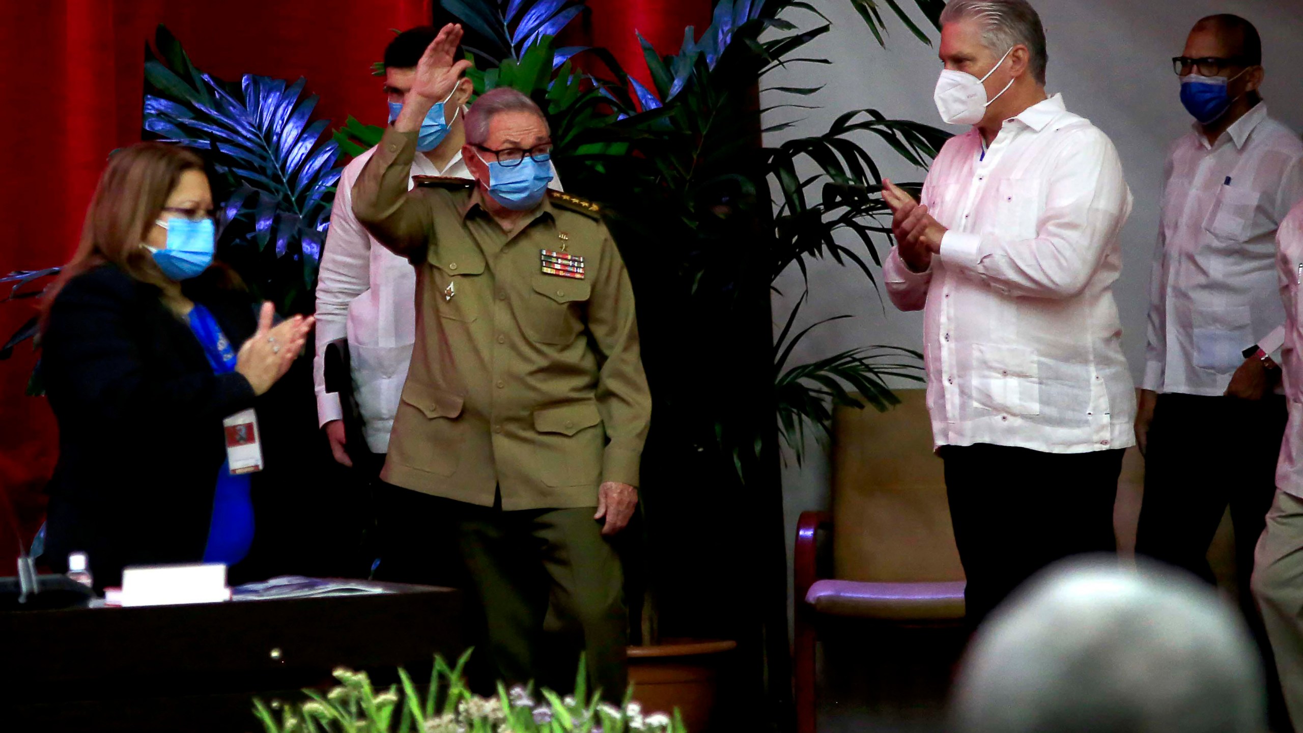 Raul Castro, first secretary of the Communist Party and former president, waves to members at the VIII Congress of the Communist Party of Cuba's opening session, as Cuban President Miguel Diaz-Canel, right, applauds at the Convention Palace, in Havana, Cuba, Friday, April 16, 2021. (Ariel Ley Royero/ACN via AP)