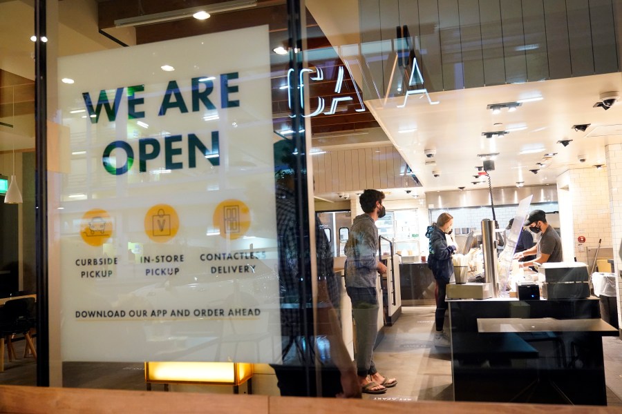 This Tuesday, March 16, 2021, file photo shows a sign advertising a restaurant opening, in Santa Monica, Calif. California has added 119.600 new jobs in March. It's the second straight month of growth following a year of enormous losses and inconsistent gains during the pandemic. (AP Photo/Marcio Jose Sanchez, File)