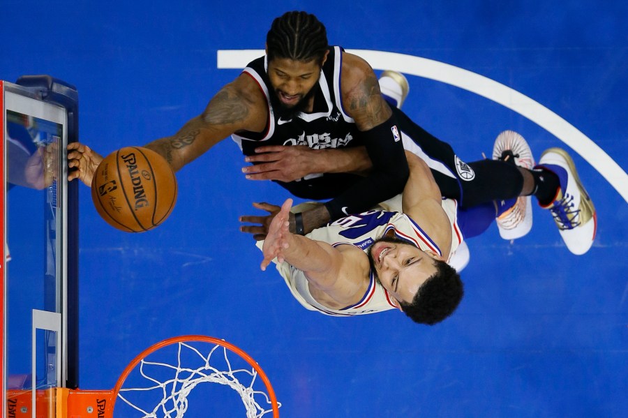 Los Angeles Clippers' Paul George, top, goes up for a shot against Philadelphia 76ers' Ben Simmons during the second half of an NBA basketball game in Philadelphia April 16, 2021. (Matt Slocum / Associated Press)