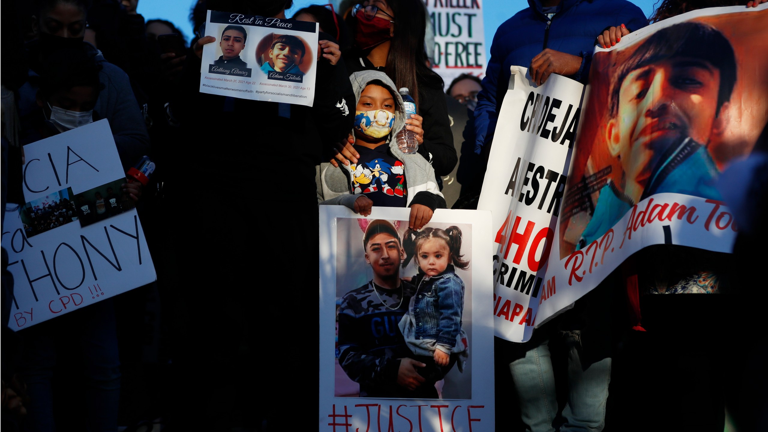 Demonstrators protest the fatal police shooting of 13-year-old Adam Toledo at an April 16, 2021, rally in Logan Park in Chicago. (Shafkat Anowar / Associaed Press)