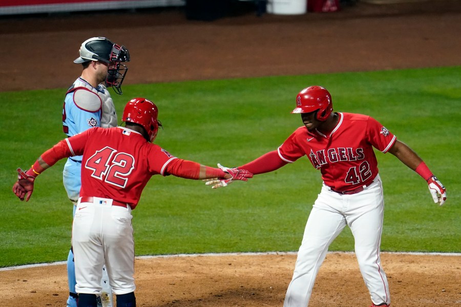 Los Angeles Angels' Justin Upton, right, celebrates his grand slam at home plate with Luis Rengifo during the seventh inning of a baseball game against the Minnesota Twins in Anaheim on April 16, 2021. (Marcio Jose Sanchez / Associated Press)