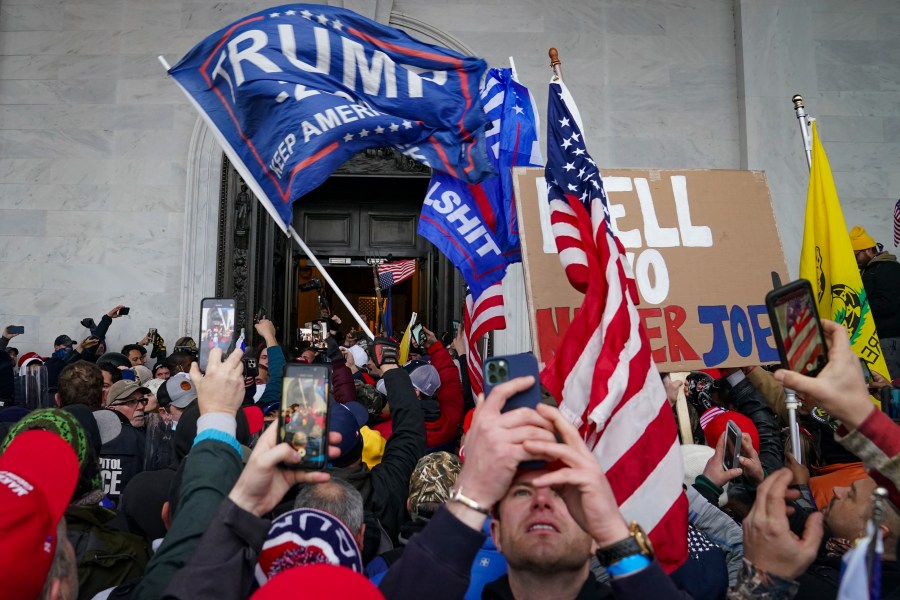 In this Jan. 6, 2021, file photo, Trump supporters gather outside the Capitol in Washington. Some people charged with storming the U.S. Capitol on Jan. 6 are claiming they were only there to record history as journalists, not join a deadly insurrection. Experts say it's unlikely that they can mount a viable defense on First Amendment free speech grounds, but some appear intent on trying. (AP Photo/John Minchillo, File)