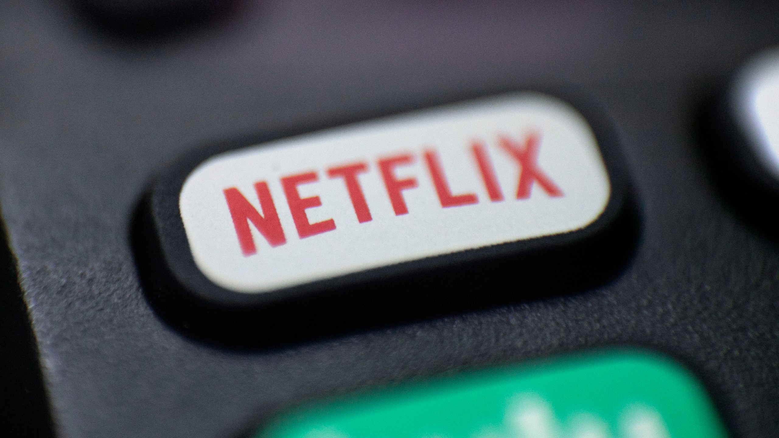 This Aug. 13, 2020 photo shows a logo for Netflix on a remote control in Portland, Ore. Netflix’s rapid subscriber growth is slowing far faster than anticipated, Tuesday, April 20, 2021, as people who have been cooped at home during the pandemic are able to get out and do other things again. The video streaming service added 4 million more worldwide subscribers from January through March, its smallest gain during that three-month period in four years. (AP Photo/Jenny Kane, File)