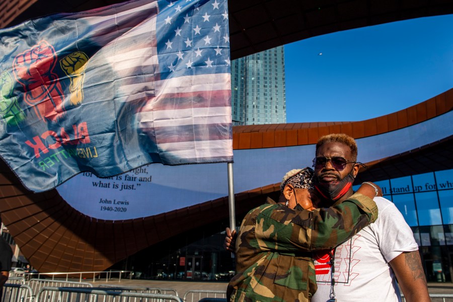 Ingrid Noel, 51, left, weeps on the shoulder of Robert Bolden, at a rally outside the Barclays Center in Brooklyn on April 20, 2021. Former Minneapolis police Officer Derek Chauvin has been convicted of murder and manslaughter in the death of George Floyd. (Brittainy Newman / Associated Press)