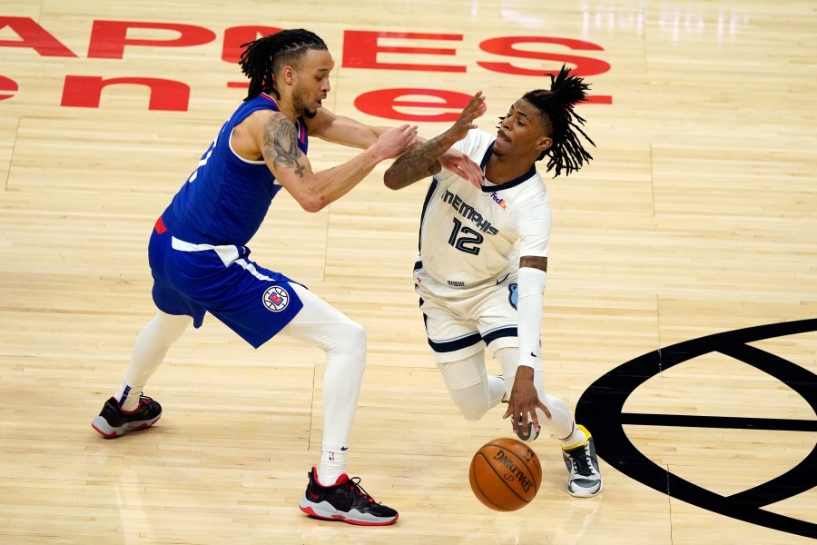 Memphis Grizzlies guard Ja Morant (12) is defended by Los Angeles Clippers guard Amir Coffey during the first half of an NBA basketball game in Los Angeles on April 21, 2021. (Marcio Jose Sanchez / Associated Press)