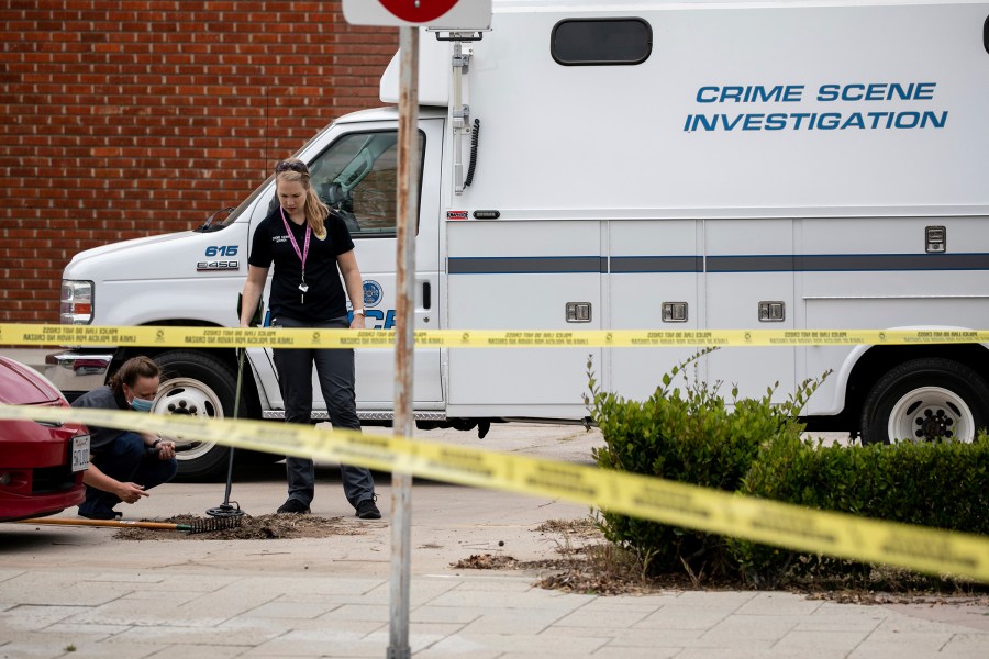 Escondido Police Department investigators search for evidence after an officer shot and killed a man who police said was hitting cars with a metal pry bar in Escondido on April 21, 2021. (Sam Hodgson/The San Diego Union-Tribune via Associated Press)