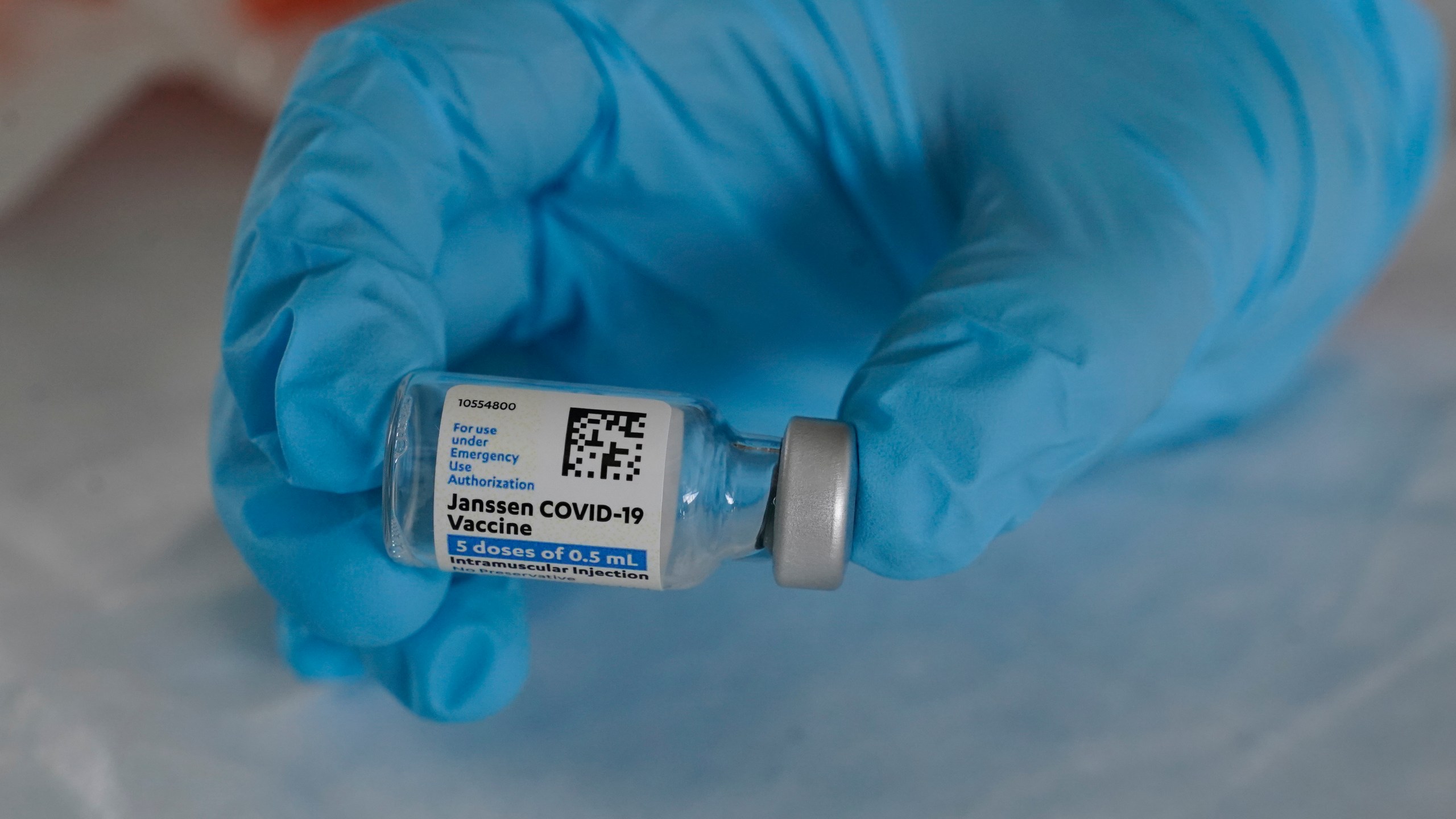 In this March 3, 2021, file photo, U.S. Army medic Kristen Rogers, of Waxhaw, N.C., holds a vial of the Johnson & Johnson COVID-19 vaccine in North Miami, Fla. With the U.S. pause of the vaccine, authorities are weighing whether to resume the shots the way European regulators decided to -- with warnings of a “very rare” risk. New guidance is expected late Friday, April 23, after a government advisory panel deliberates a link between the shot and a handful of vaccine recipients who developed highly unusual blood clots. (AP Photo/Marta Lavandier, File)