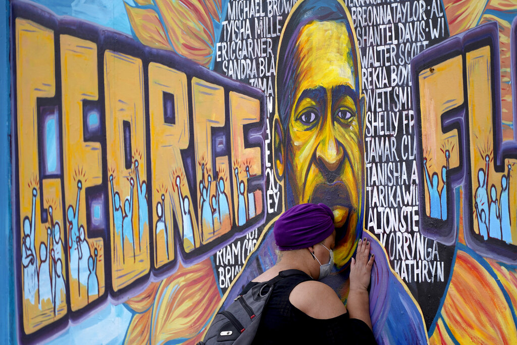 Damarra Atkins paid her respects to George Floyd at a mural at George Floyd Square, Friday, April 23, 2021, in Minneapolis. (AP Photo/Julio Cortez)