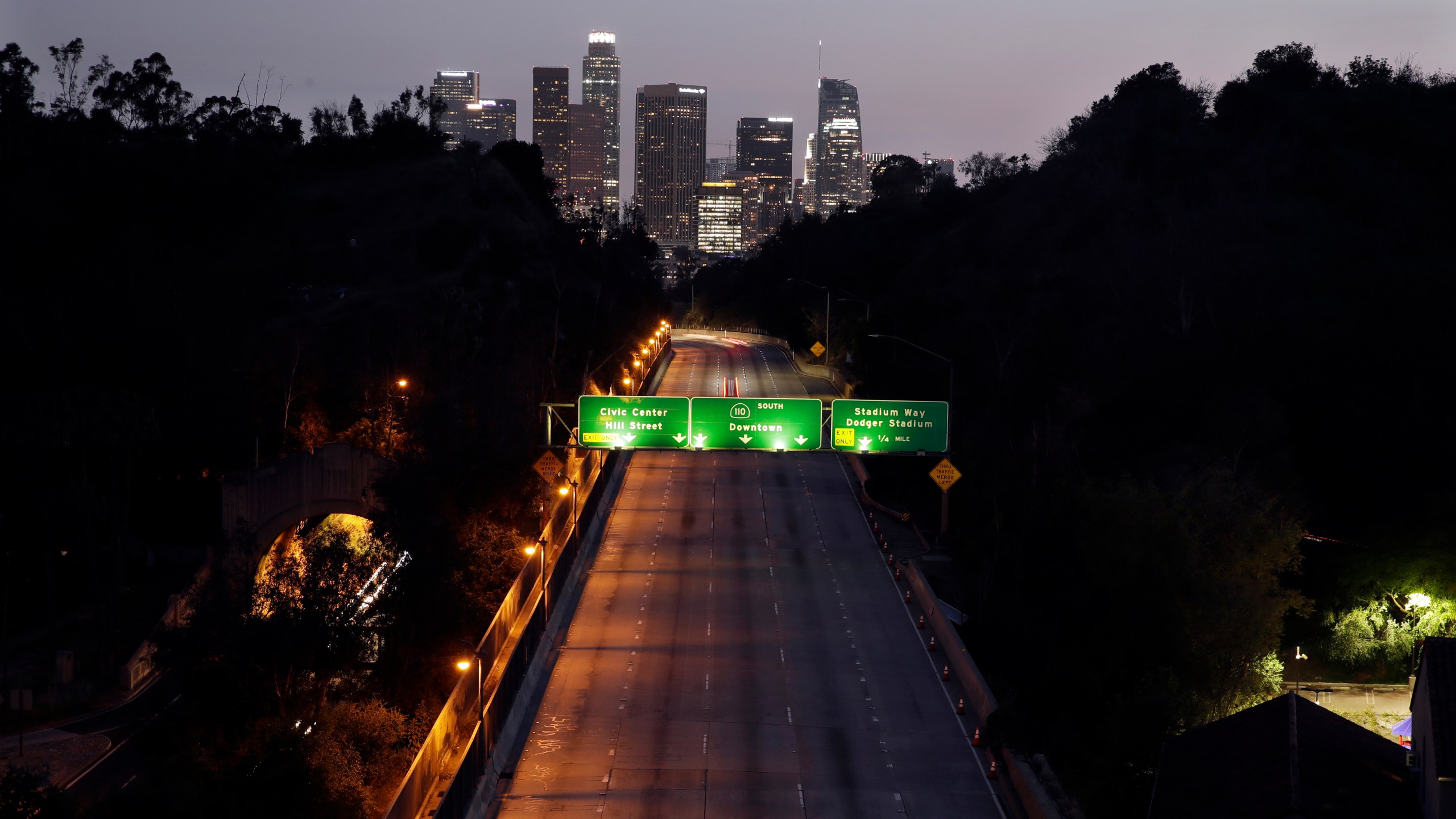 In this April 2, 2020, file photo, light traffic is seen on the 110 freeway with the city skyline in the background in Los Angeles. (AP Photo/Marcio Jose Sanchez, File)