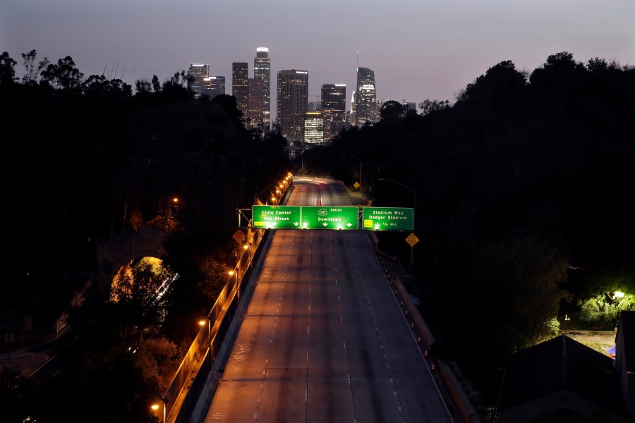 In this April 2, 2020, file photo, light traffic is seen on the 110 freeway with the city skyline in the background in Los Angeles. (AP Photo/Marcio Jose Sanchez, File)