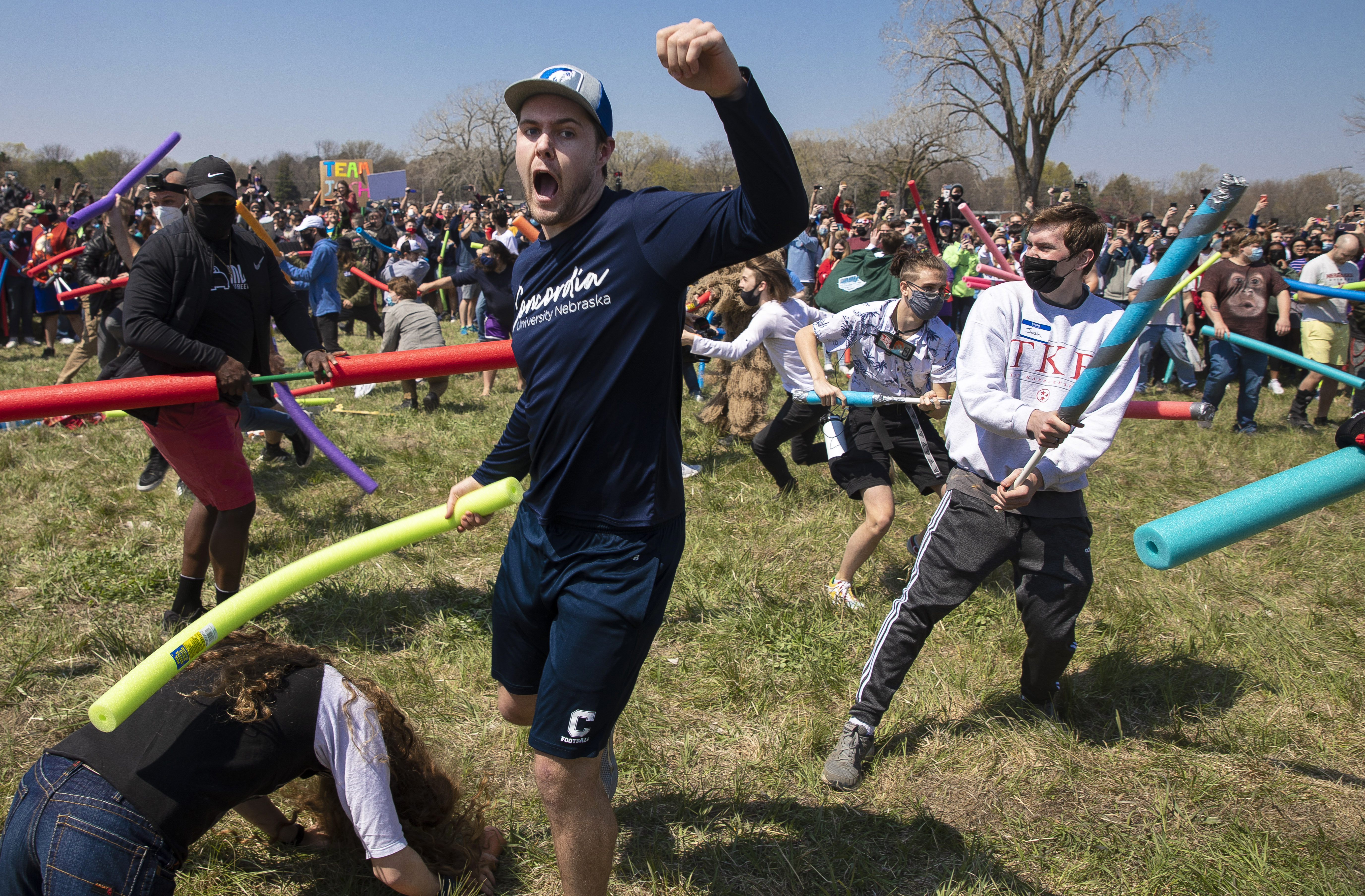 Multiple people with the name Josh duked it out with pool noodle out to find out who is the rightful owner of the name Josh via a battle royale in an open green space in Air Park on Saturday, April 24, 2021, in Lincoln, Neb. What started as a mid-pandemic joke took on life Saturday, as a mixed bag of individuals sharing only their name came to battle it out. The winner was to be declared the rightful owner of the name. (Kenneth Ferriera/Lincoln Journal Star via AP)