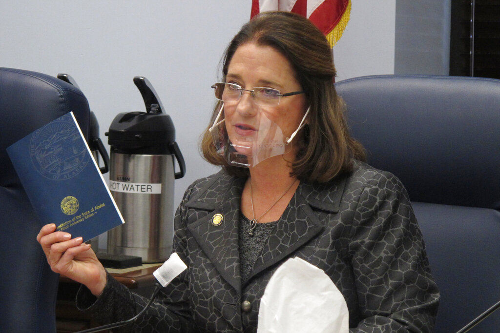 In this Jan. 27, 2021 file photo, Alaska state Sen. Lora Reinbold, an Eagle River Republican, holds a copy of the Alaska Constitution during a committee hearing in Juneau, Alaska. (AP Photo/Becky Bohrer, File)