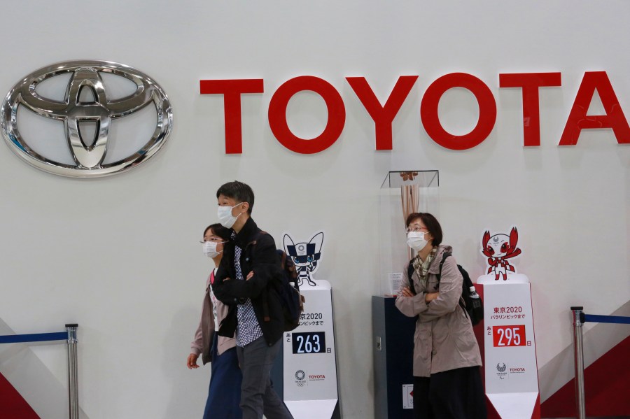 In this Nov. 2, 2020, file photo, visitors walk at a Toyota showroom in Tokyo. (AP Photo/Koji Sasahara, File)