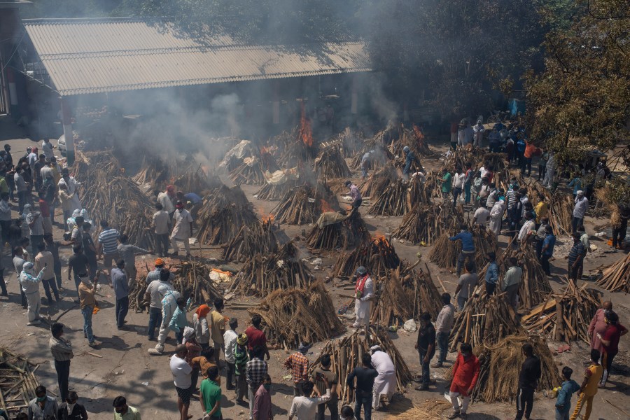 In this April 24, 2021, file photo, multiple funeral pyres of those who died of COVID-19 burn at a ground that has been converted into a crematorium for the mass cremation of coronavirus victims, in New Delhi, India. (AP Photo/Altaf Qadri, File)