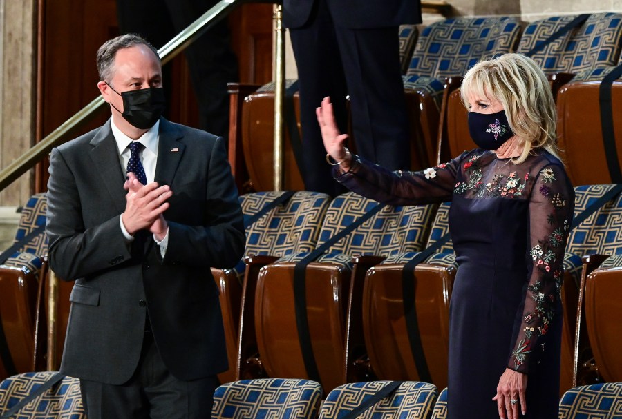 First lady Jill Biden waves as she arrives prior to President Joe Biden arriving to address a joint session of Congress, Wednesday, April 28, 2021, in the House Chamber at the U.S. Capitol in Washington, as Doug Emhoff looks on. (Jim Watson/Pool via AP)