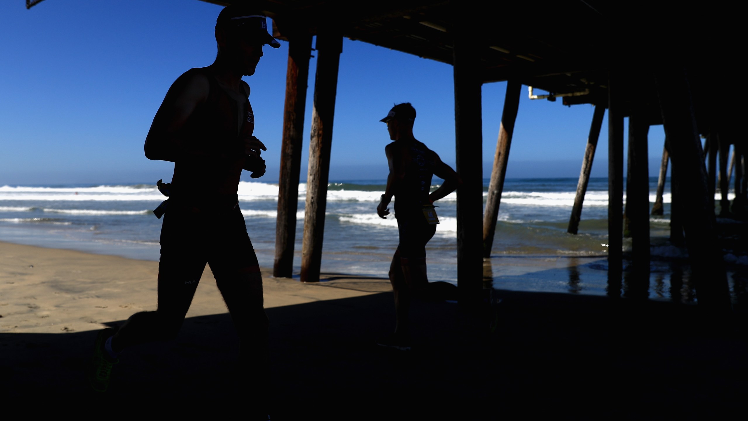 Competitors run under the Imperial Beach pier during the run portion of the IRONMAN 70.3 Superfrog on Sept. 16, 2018 in Imperial Beach, California. (Sean M. Haffey/Getty Images for IRONMAN)