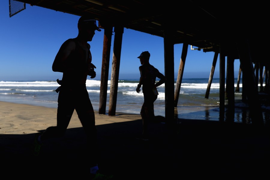 Competitors run under the Imperial Beach pier during the run portion of the IRONMAN 70.3 Superfrog on Sept. 16, 2018 in Imperial Beach, California. (Sean M. Haffey/Getty Images for IRONMAN)