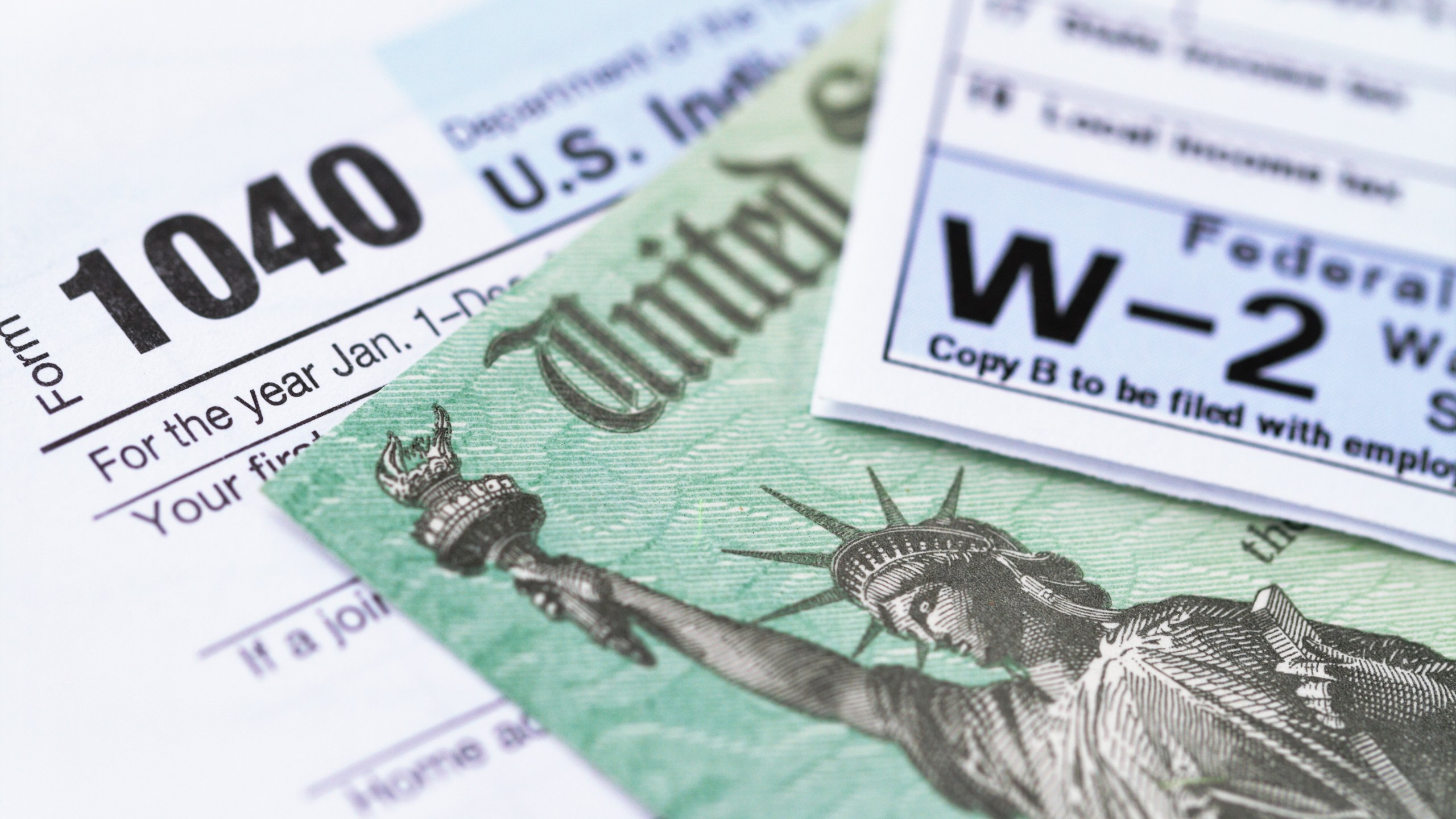 An IRS tax form with a tax refund check are seen in a file photo. (iStock/Getty Images Plus)