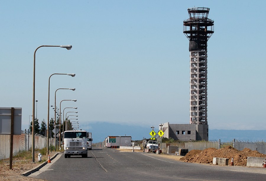 Trucks drive down a road near a half-completed 236-foot FAA control tower at Oakland International Airport on August 3, 2011 in Oakland. (Justin Sullivan/Getty Images)