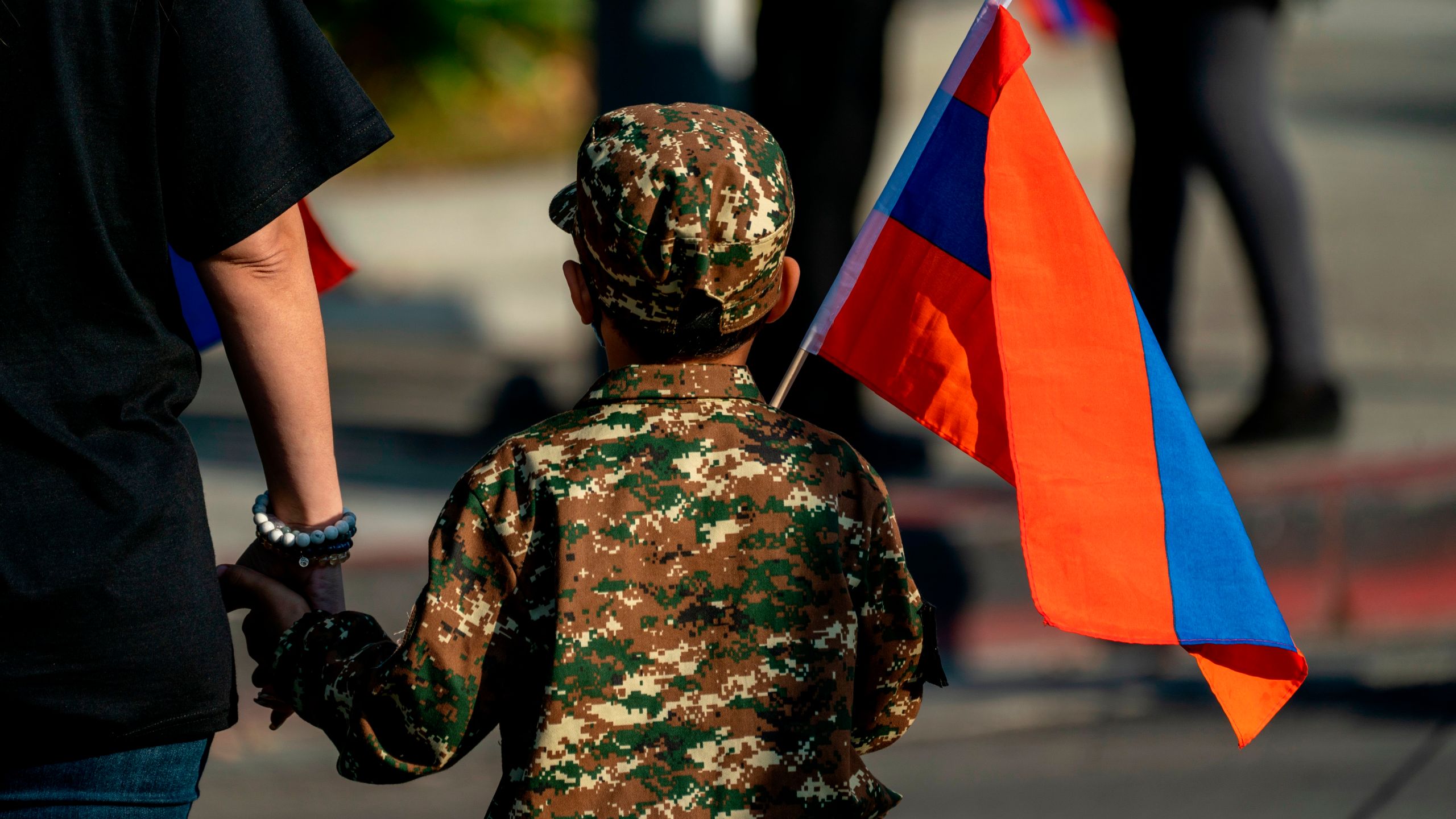 A boy holding an Armenian flag marches with others from Pan Pacific Park to the Consulate General of Turkey in Los Angeles, California, during a protest in support of Armenia and Karabakh amid the territorial dispute with Azerbaijan over Nagorno-Karabakh, on Oct. 11, 2020. (KYLE GRILLOT/AFP via Getty Images)