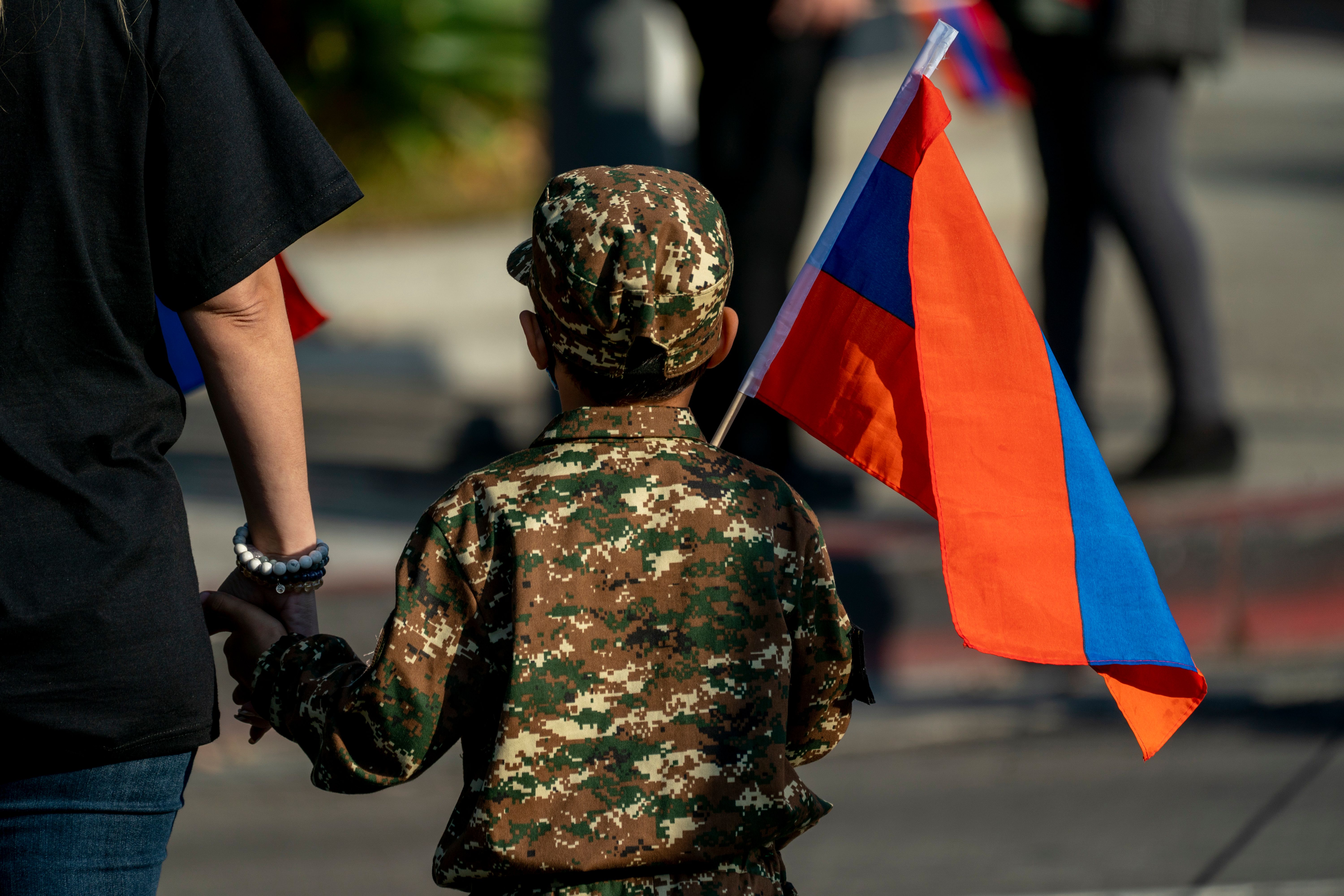 A boy holding an Armenian flag marches with others from Pan Pacific Park to the Consulate General of Turkey in Los Angeles, California, during a protest in support of Armenia and Karabakh amid the territorial dispute with Azerbaijan over Nagorno-Karabakh, on Oct. 11, 2020. (KYLE GRILLOT/AFP via Getty Images)