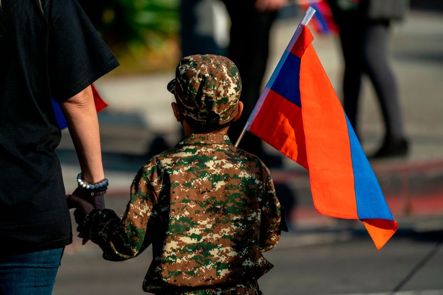 A boy holding an Armenian flag marches with others from Pan Pacific Park to the Consulate General of Turkey in Los Angeles, California, during a protest in support of Armenia and Karabakh amid the territorial dispute with Azerbaijan over Nagorno-Karabakh, on Oct. 11, 2020. (KYLE GRILLOT/AFP via Getty Images)