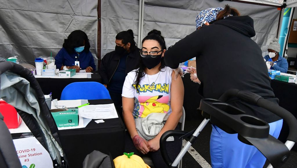 Irene Orioha receives her Pfizer Covid-19 vaccine at a public housing project pop-up site targeting vulnerable communities in Los Angeles, California on March 10, 2021. (FREDERIC J. BROWN/AFP via Getty Images)