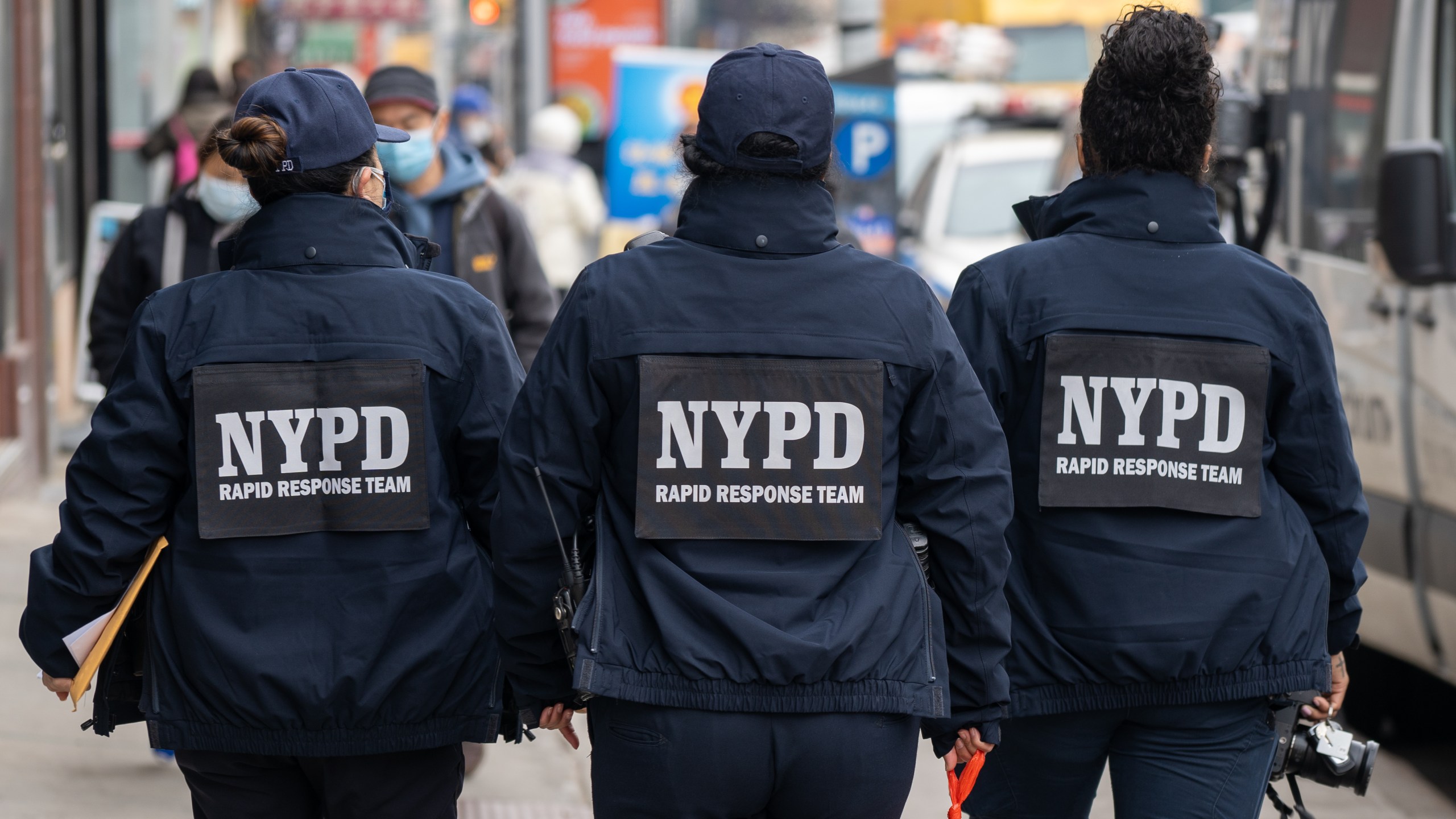 NYPD officers hand out information about hate crimes in Asian communities on March 17, 2021 in New York City. (David Dee Delgado/Getty Images)