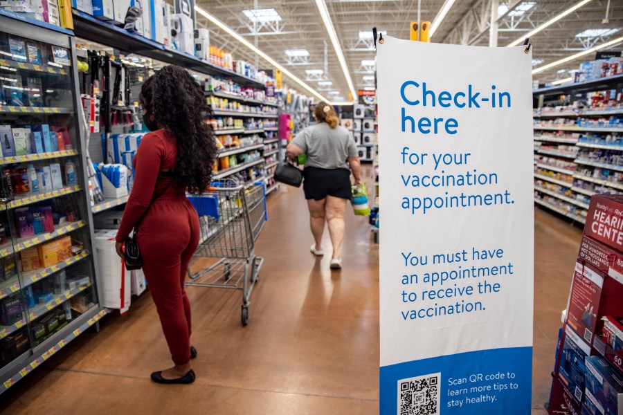 Shoppers walk around a COVID-19 vaccine check in area inside a Walmart in San Antonio, Texas, on March 29, 2021. (Sergio Flores / Getty Images)