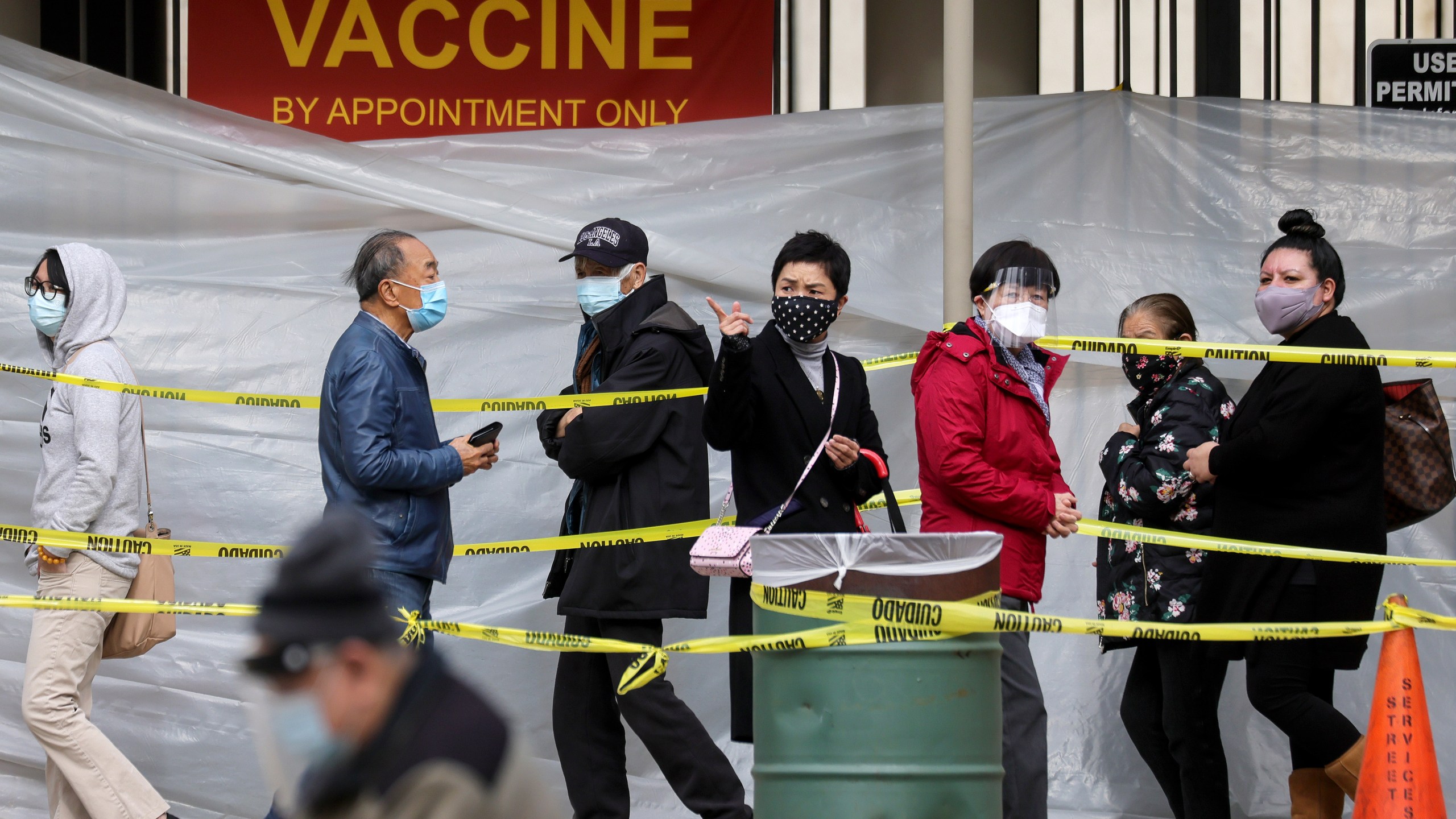 People with appointments walk in line to receive the COVID-19 vaccine at a vaccination site at Lincoln Park amid eased lockdown restrictions on January 28, 2021 in Los Angeles, California. (Mario Tama/Getty Images)