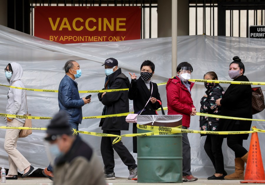 People with appointments walk in line to receive the COVID-19 vaccine at a vaccination site at Lincoln Park amid eased lockdown restrictions on January 28, 2021 in Los Angeles, California. (Mario Tama/Getty Images)