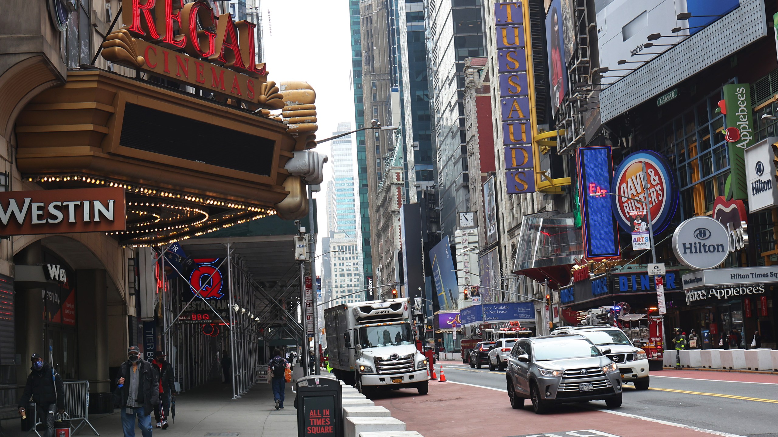 People walk past the Regal Cinemas in Times Square on March 24, 2021 in New York City. (Michael M. Santiago/Getty Images)