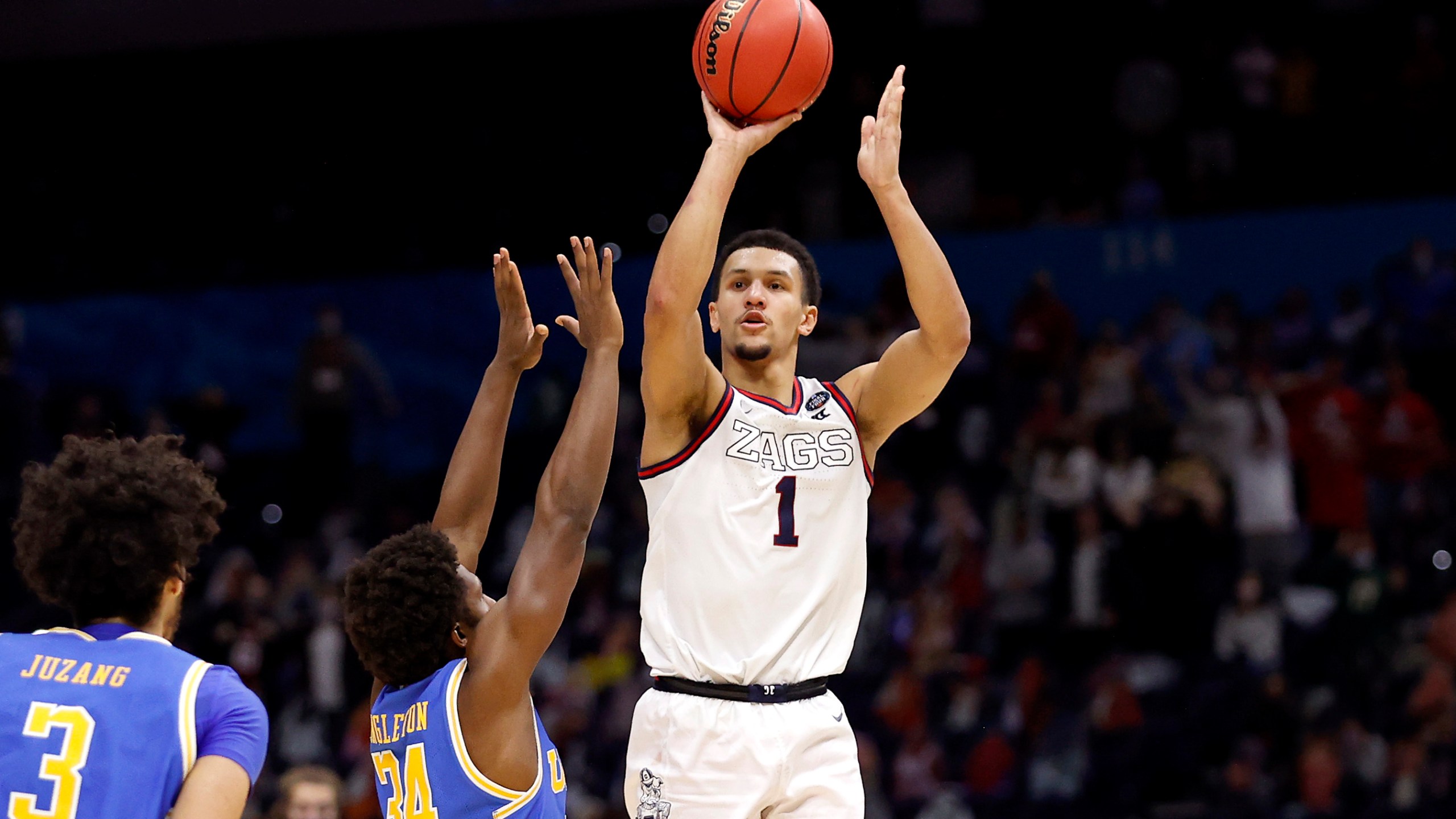 Jalen Suggs #1 of the Gonzaga Bulldogs shoots a game-winning three point basket in overtime to defeat the UCLA Bruins 93-90 during the 2021 NCAA Final Four semifinal at Lucas Oil Stadium on April 03, 2021 in Indianapolis, Indiana. (Photo by Jamie Squire/Getty Images)