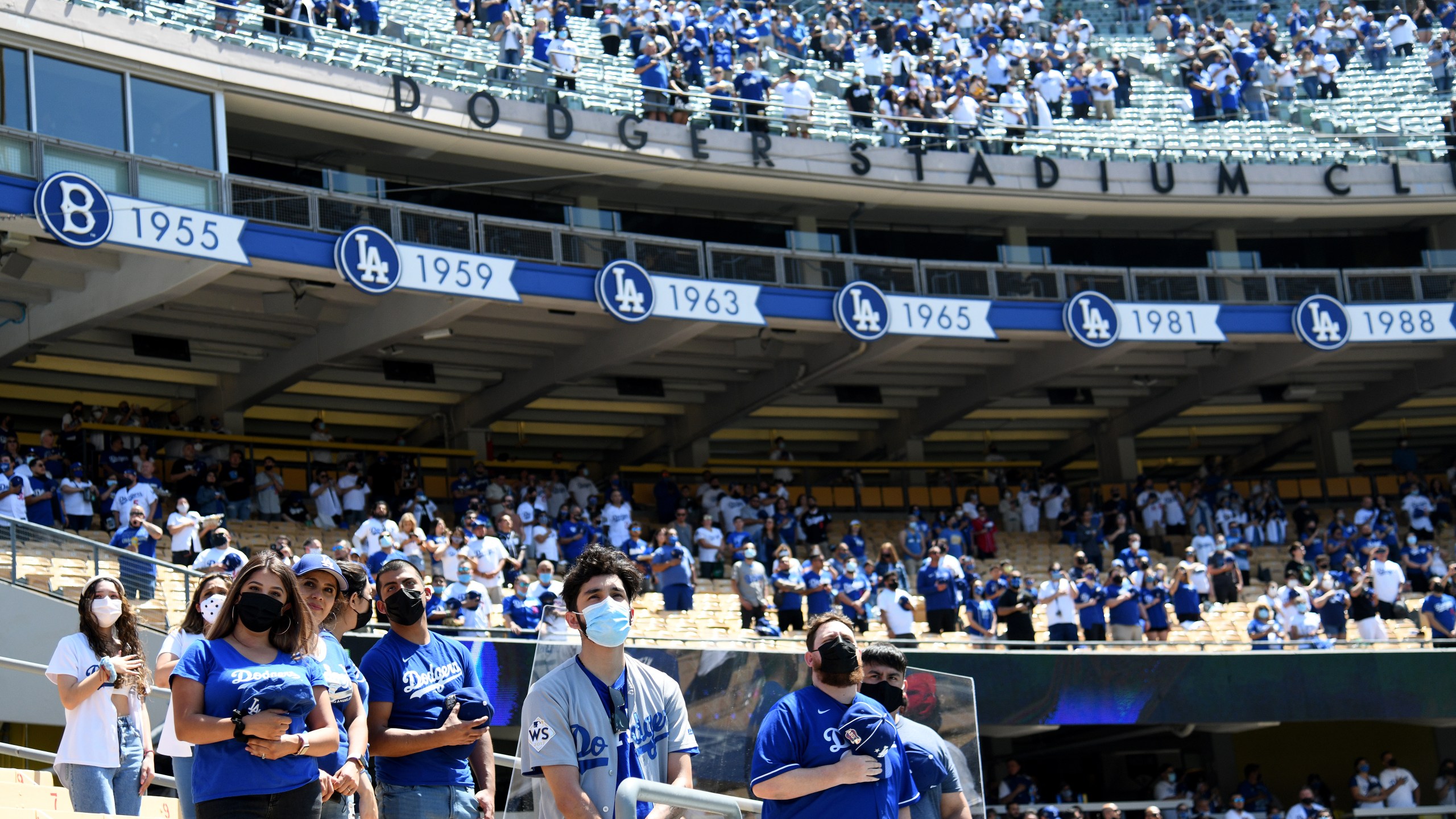 Fans stand for the National Anthem before the game between the Washington Nationals and the Los Angeles Dodgers during the 2021 MLB season home opening game at Dodger Stadium on April 9, 2021. (Harry How/Getty Images)