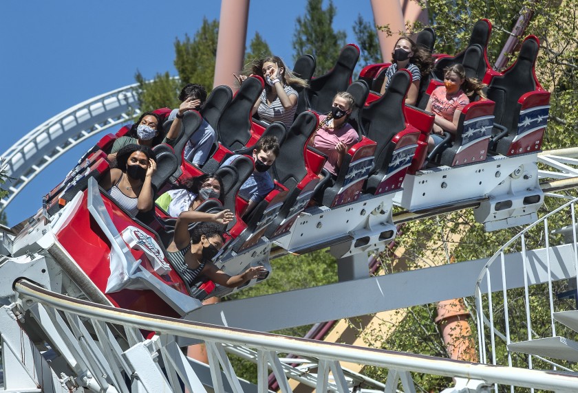 People ride a roller coaster at Six Flags Magic Mountain in Valencia on April 2, 2021, as the amusement park reopened for the first time in about a year due to the COVID-19 pandemic. (Mel Melcon / Los Angeles Times)