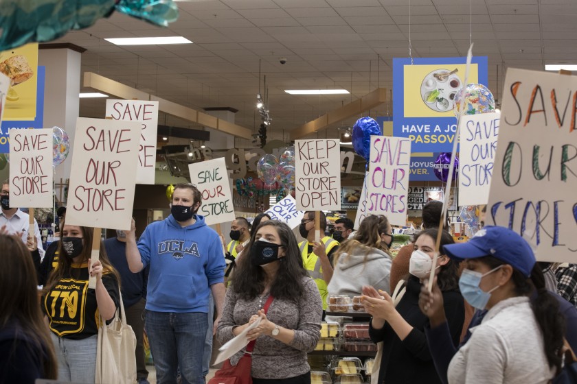 Demonstrators take their message inside the Ralphs supermarket in L.A.'s Pico-Robertson neighborhood to protest its planned closure.(Myung J. Chun / Los Angeles Times)