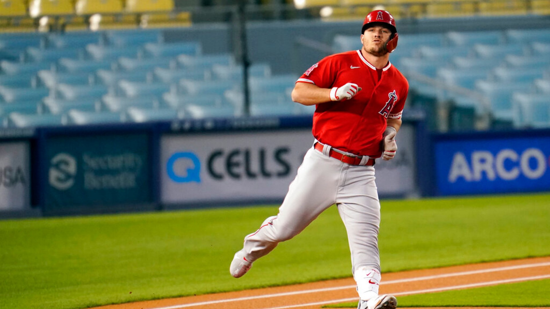 Los Angeles Angels' Mike Trout rounds first base as he flies out during the first inning of a spring training exhibition baseball game against the Los Angeles Dodgers, Monday, March 29, 2021, in Los Angeles. (AP Photo/Marcio Jose Sanchez)