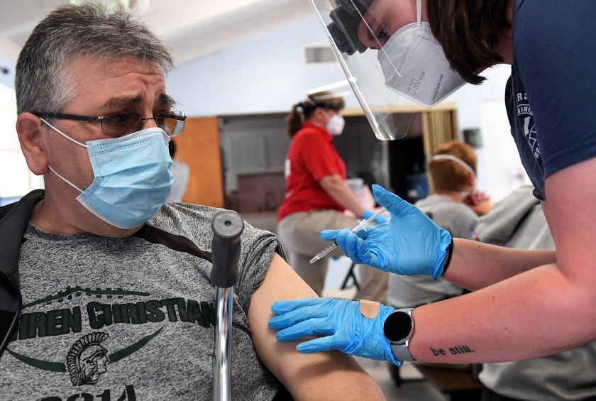 Jose Gutierrez receives the Johnson & Johnson vaccine from paramedic Madeline Plaut at a pop-up clinic in Hawaiian Gardens on April 3, 2021. (Wally Skalij/ Los Angeles Times)