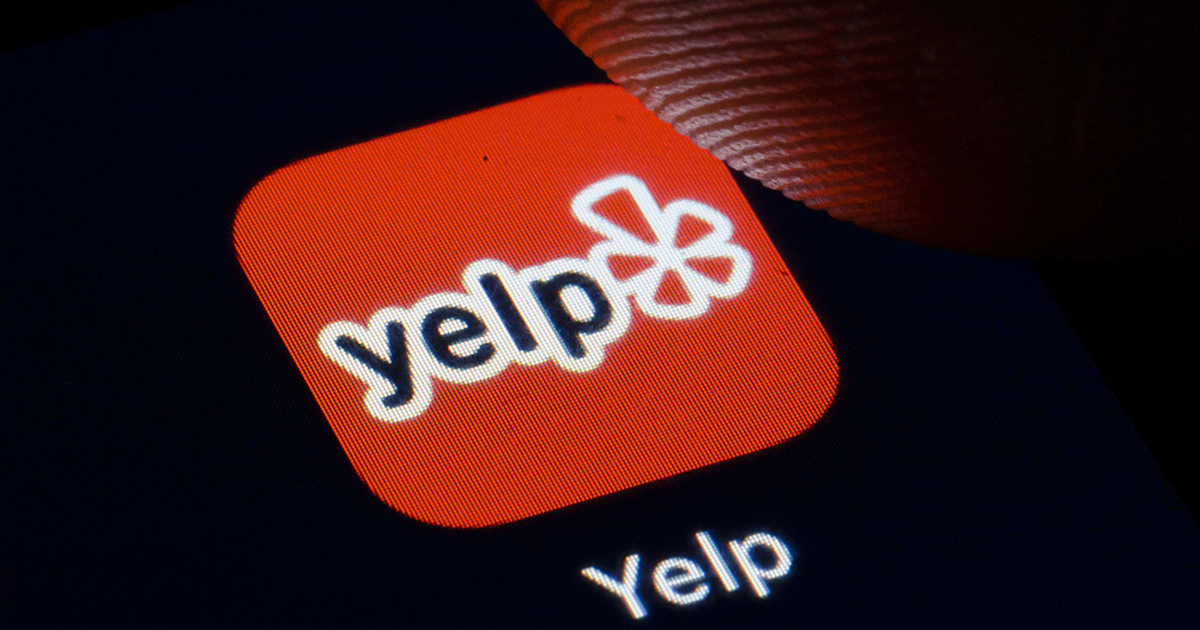 The Yelp logo is displayed on a smartphone on November 27, 2019 in Berlin, Germany. (Thomas Trutschel/Photothek via Getty Images)