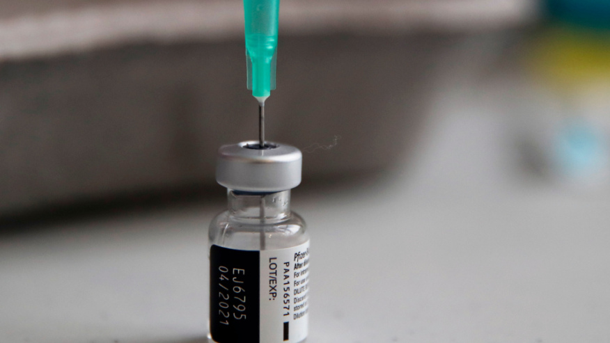 In this Jan. 18, 2021, file photo, a vial of the Pfizer-BioNTech vaccine against COVID-19 is prepared at a vaccination center of the 3rd district, in Paris. (AP Photo/Francois Mori, File)