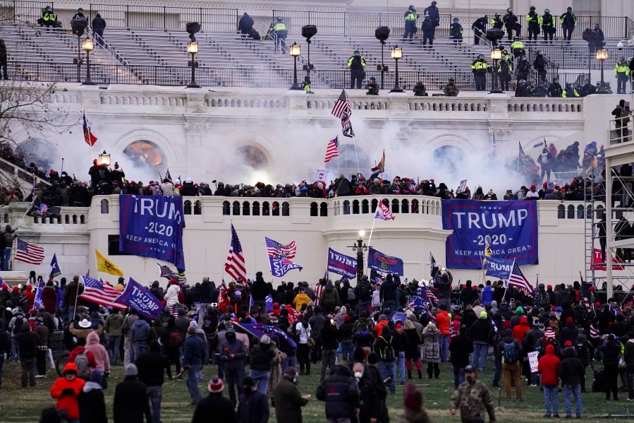 In this Jan. 6. 2021, file photo, people storm the Capitol in Washington. (AP Photo/John Minchillo)