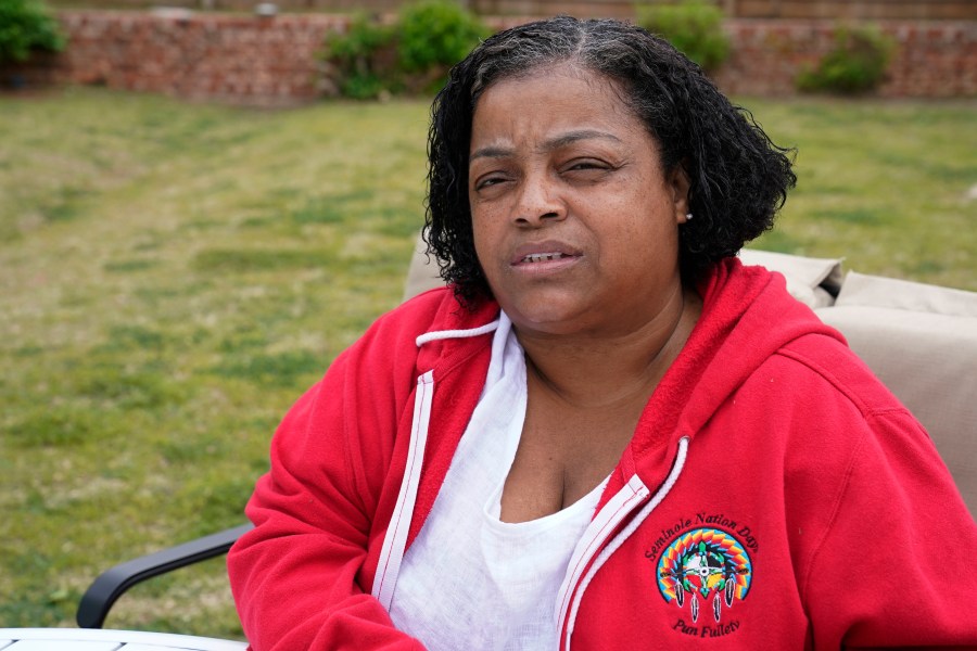 LeEtta Osborne-Sampson is pictured outside her home Monday, April 26, 2021, in Oklahoma City. Sampson-Osborn, a Seminole Freedman who has a tribal identification card and serves on the tribe's governing council, said when she went to the Indian Health Services clinic to get a vaccination in February, a worker at the clinic told her the Seminole Nation doesn't recognize Freedmen for health services. (AP Photo/Sue Ogrocki)