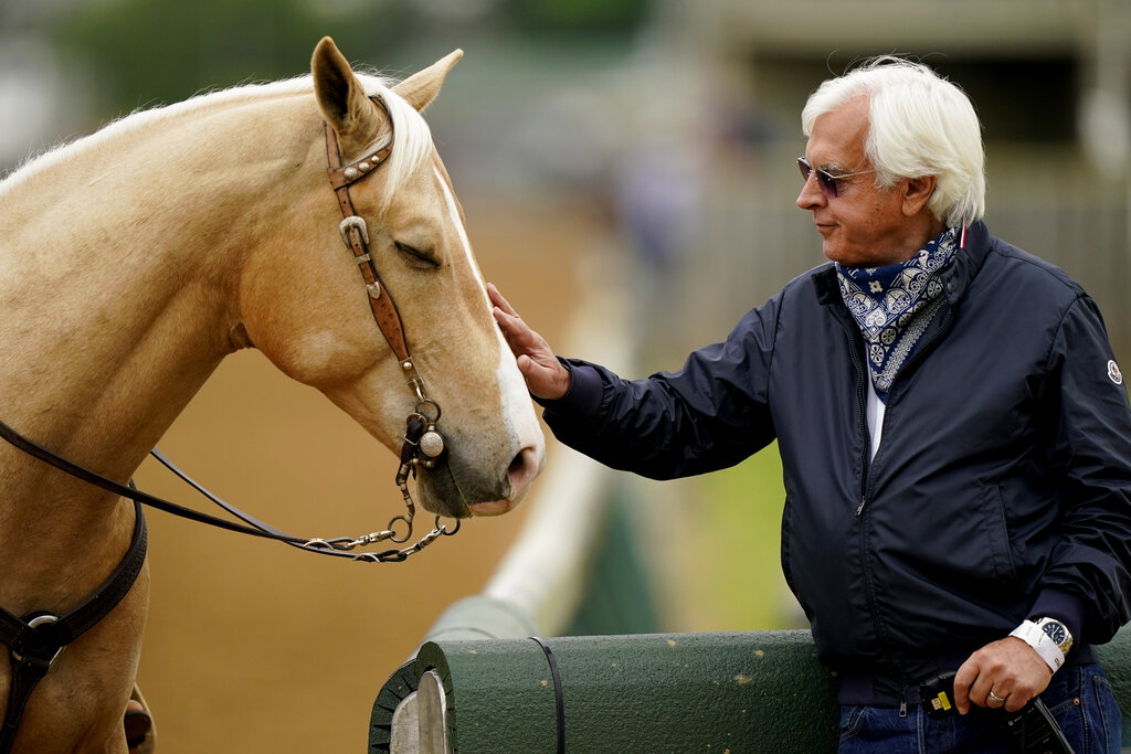 Trainer Bob Baffert pets an outrider's horse while watching workouts at Churchill Downs Wednesday, April 28, 2021, in Louisville, Ky. The 147th running of the Kentucky Derby is scheduled for Saturday, May 1. (AP Photo/Charlie Riedel)