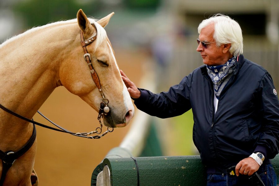 Trainer Bob Baffert pets an outrider's horse while watching workouts at Churchill Downs Wednesday, April 28, 2021, in Louisville, Ky. The 147th running of the Kentucky Derby is scheduled for Saturday, May 1. (AP Photo/Charlie Riedel)